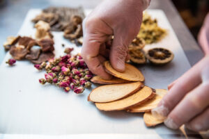 Raw Herbs showing hand holding herbs