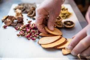 Raw Herbs showing hand holding herbs